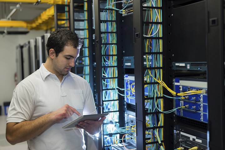 Image - technician providing critical maintenance to a business server rack