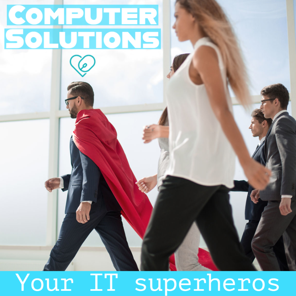 Text - computer solutions Your IT heroes
Image - a group of people walking behind a man in a red cape
