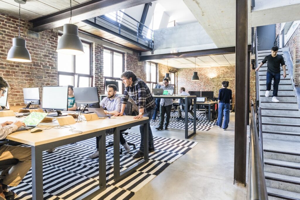 Two professionals shaking hands in a modern office, representing a successful new hire